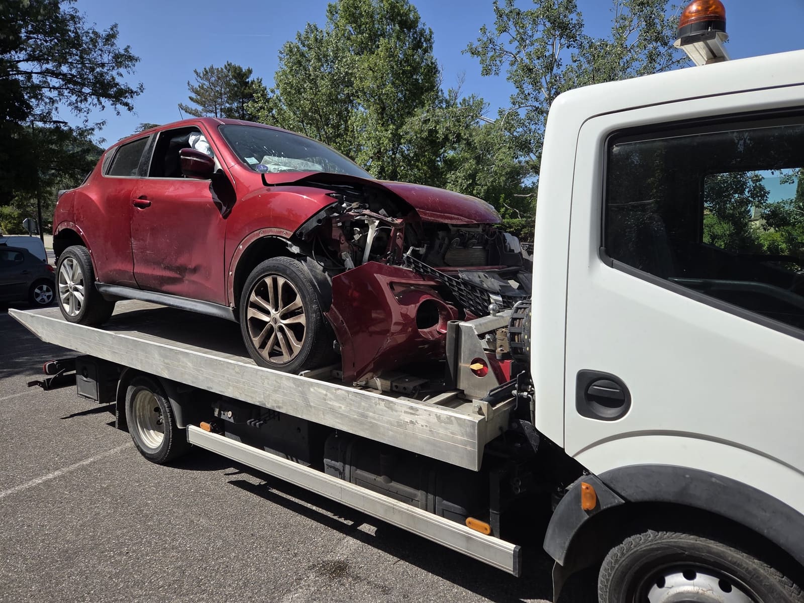 Véhicule accidenté pris en charge par Épaviste Perrin sur dépanneuse plateau.
